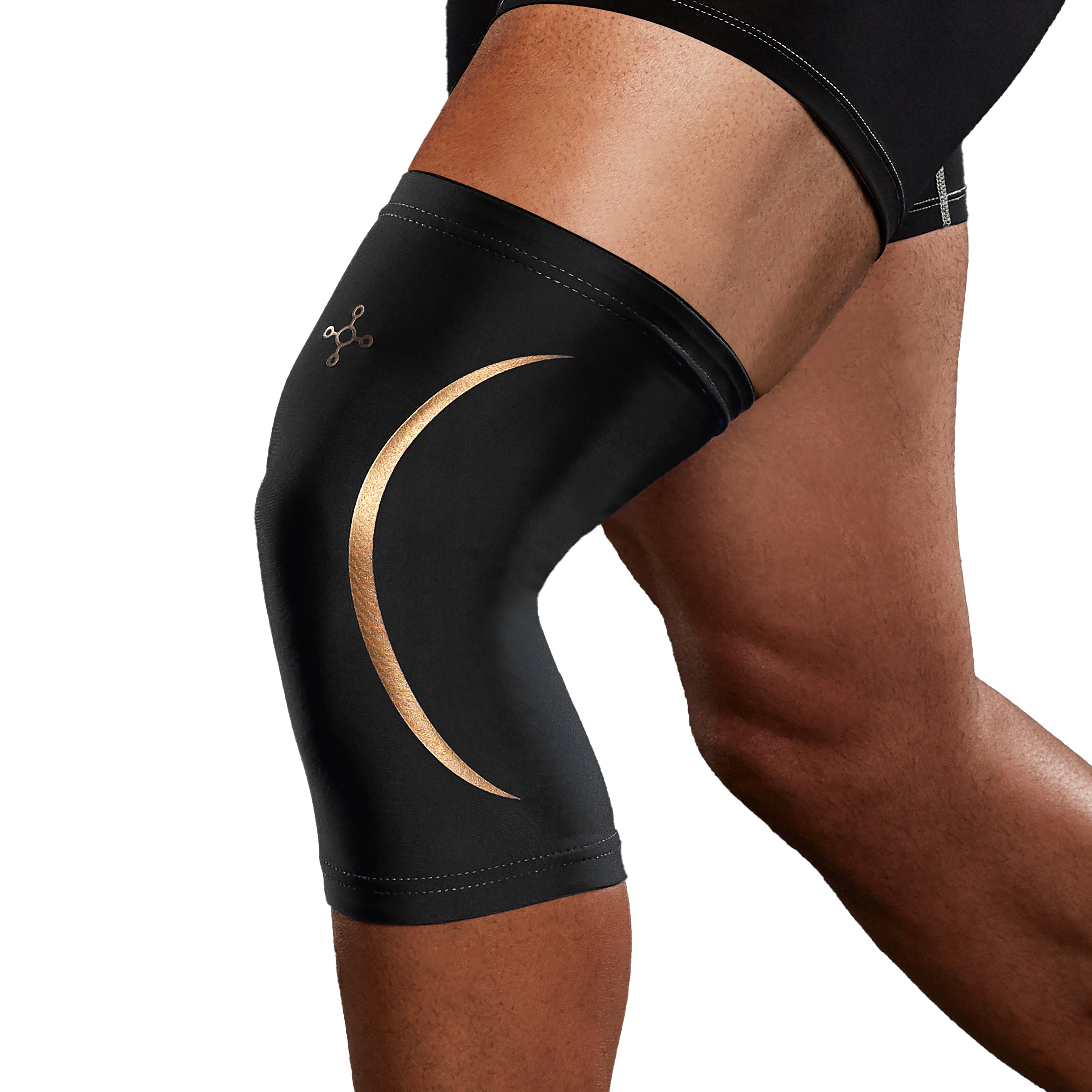 Black knee brace with a gold crescent design on a person's leg against a white background