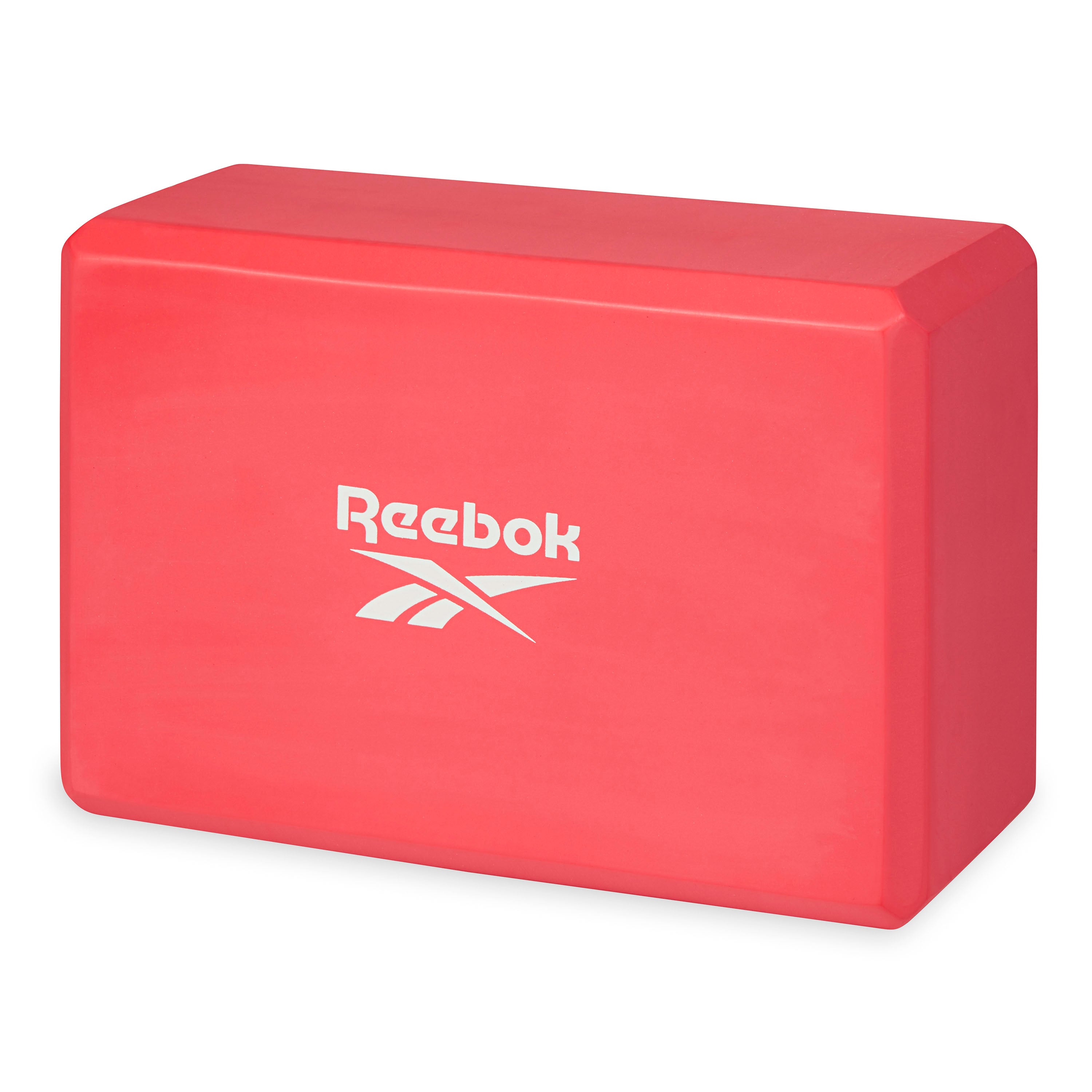 Red Reebok yoga block on a white background